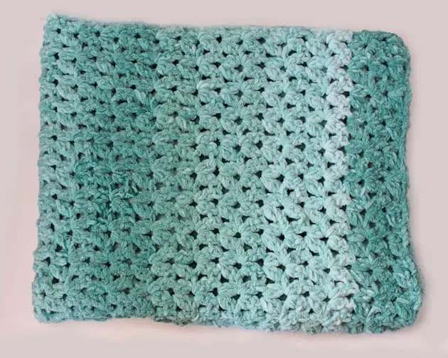 Make this quick and easy mist green chunky crochet blanket free pattern. super bulky chenille yarn - amorecraftylife.com -bernat blanket yarn -lap afghan - free printable crochet pattern - bernat blanket yarn #crochet #crochetpattern #freecrochetpattern