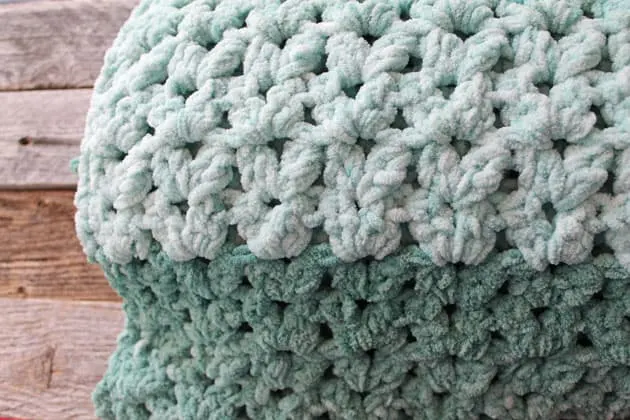 Make this quick and easy mist green chunky crochet blanket free pattern. super bulky chenille yarn - amorecraftylife.com -bernat blanket yarn -lap afghan - free printable crochet pattern - bernat blanket yarn #crochet #crochetpattern #freecrochetpattern