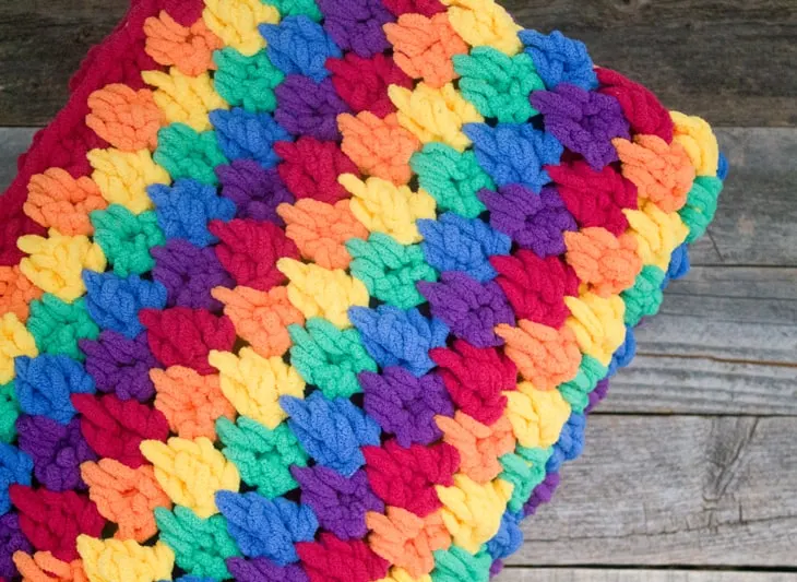 Make this colorful chunky rainbow teardrop crochet blanket free pattern. super bulky chenille yarn - amorecraftylife.com -bernat blanket yarn -lap afghan - free printable crochet pattern - bernat blanket yarn #crochet #crochetpattern #freecrochetpattern