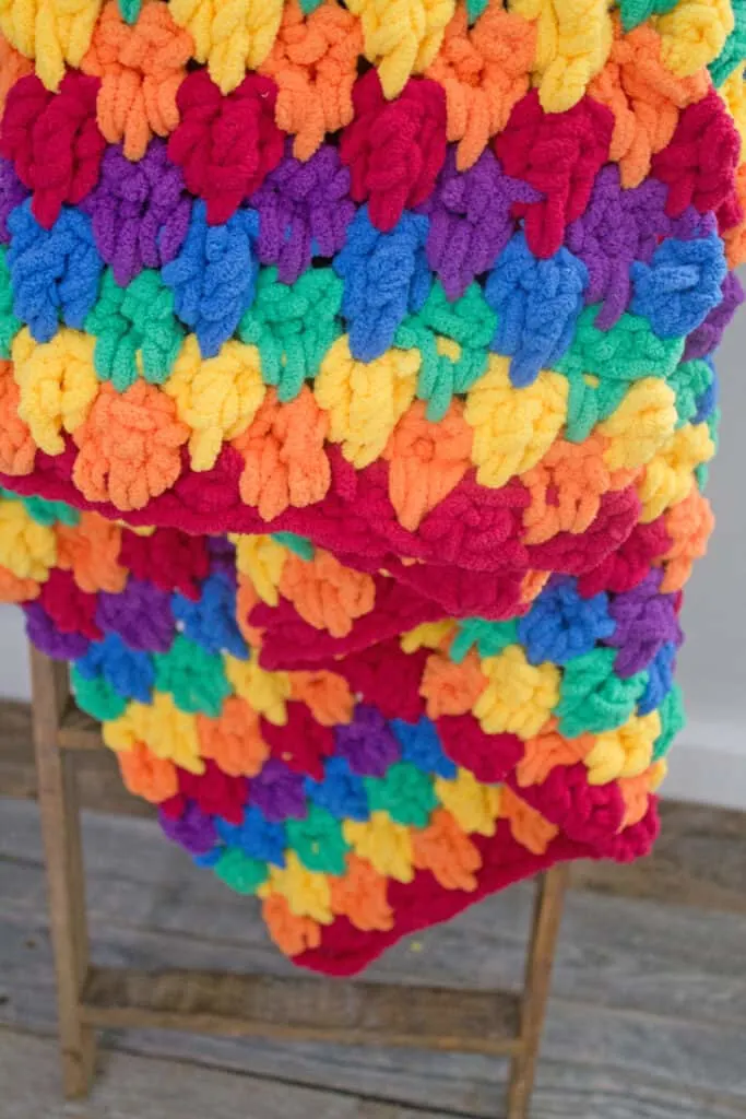 Make this colorful chunky rainbow teardrop crochet blanket free pattern. super bulky chenille yarn - amorecraftylife.com -bernat blanket yarn -lap afghan - free printable crochet pattern - bernat blanket yarn #crochet #crochetpattern #freecrochetpattern