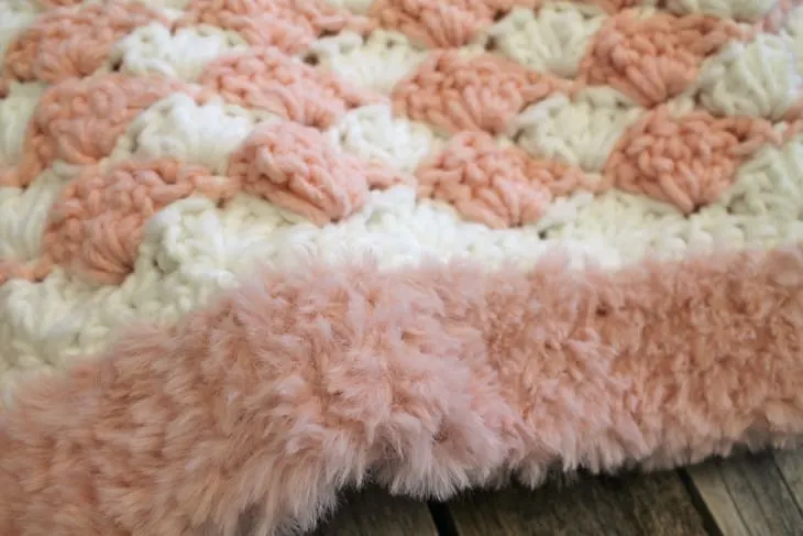 Addison Baby Blanket with Furry Border - baby girl shell crochet blanket pattern - amorecraftylife.com -bernat forever fleece yarn baby blanket - baby afghan - free printable crochet pattern chunky blanket pattern #baby #crochet #crochetpattern #freecrochetpattern