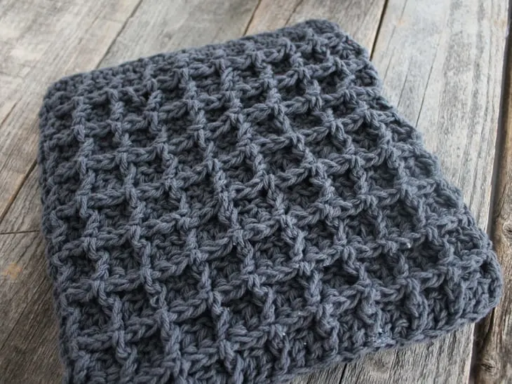 Try this easy waffle stitch potholder. This easy double thick hot pad pattern uses double crochet and front post double crochet to make a squish box texture. Free PDF available.