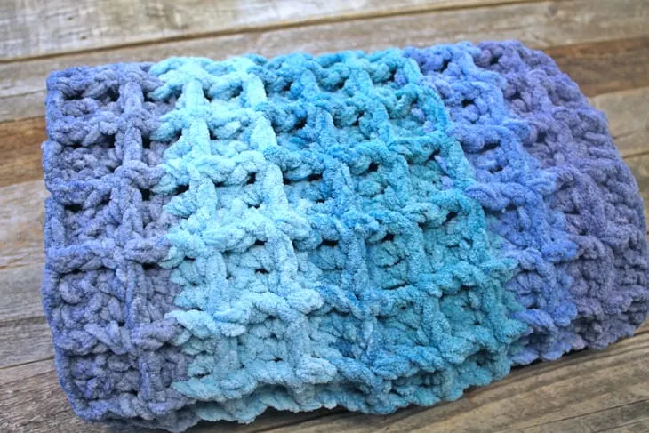 Try this ombre waffle chunky crochet baby blanket pattern. This easy pattern uses basic stitches to make this textured box.