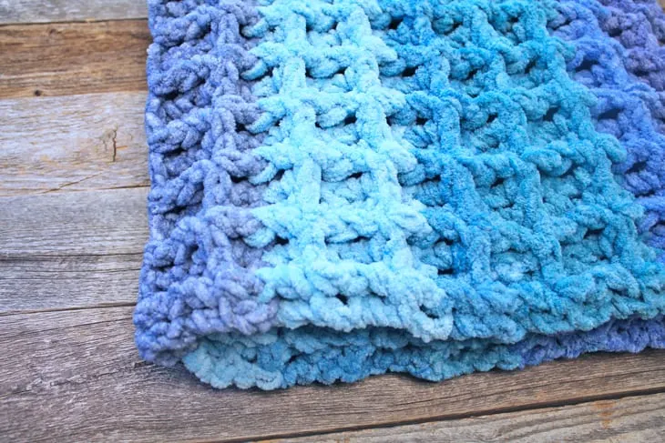 Try this ombre waffle chunky crochet baby blanket pattern. This easy pattern uses basic stitches to make this textured box.