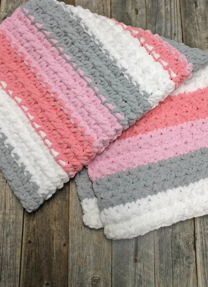 Try an easy trinity stitch crochet baby blanket pattern using bulky yarn. This self striping Bernat Blanket Yarn is soft and works up quickly.