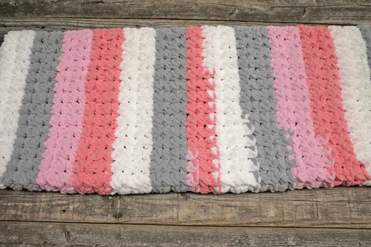 Try an easy trinity stitch crochet baby blanket pattern using bulky yarn. This self striping Bernat Blanket Yarn is soft and works up quickly.