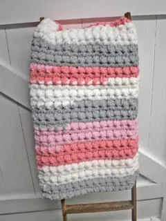 Try an easy trinity stitch crochet baby blanket pattern using bulky yarn. This self striping Bernat Blanket Yarn is soft and works up quickly.
