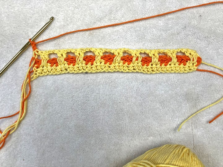 step of the interlocking block crochet stitch double crochet in the 1st 2 stitch, skip 2, chain 2.