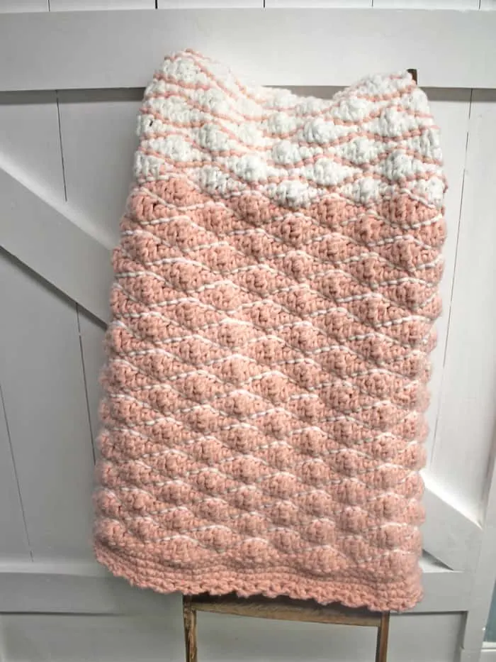 Try this free chunky baby blanket crochet pattern. This easy pattern uses a combination of basic stitches. This blanket has a pretty border. 