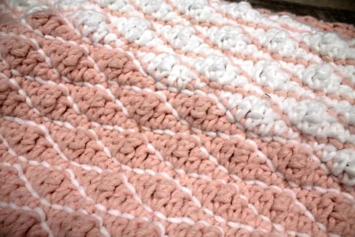 Try this free chunky baby blanket crochet pattern. This easy pattern uses a combination of basic stitches. This blanket has a pretty border. 