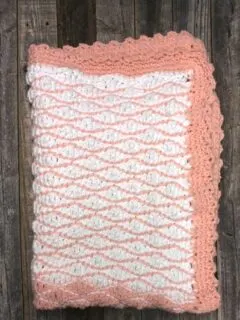 Try this free chunky baby blanket crochet pattern. This easy pattern uses a combination of basic stitches. This blanket has a pretty border.