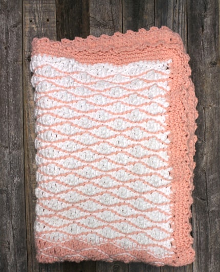 Try this free chunky baby blanket crochet pattern. This easy pattern uses a combination of basic stitches. This blanket has a pretty border.