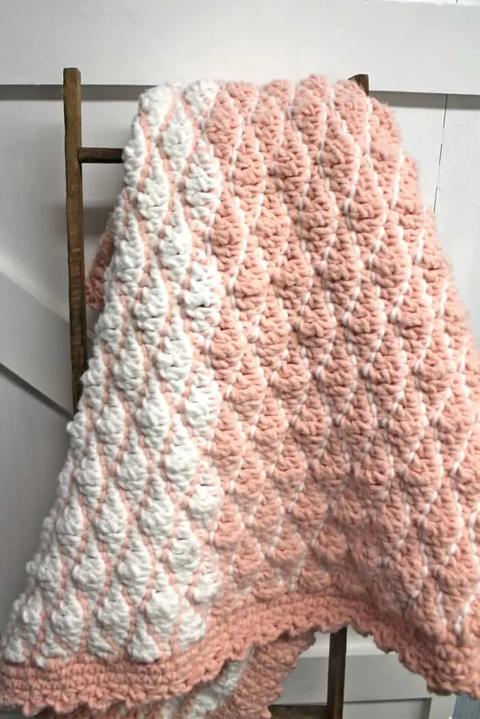 Try this free chunky baby blanket crochet pattern. This easy pattern uses a combination of basic stitches. This blanket has a pretty border. 