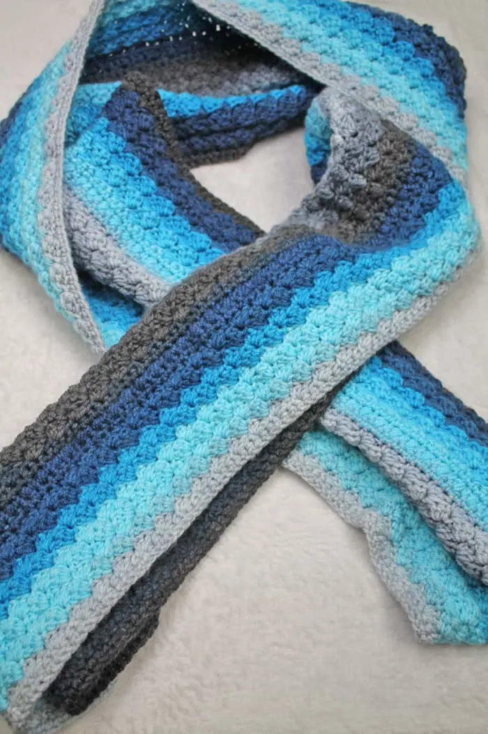 Make an easy blue striped scarf. This striped scarf is an easy repeatable pattern using Lion Brand Mandala.
