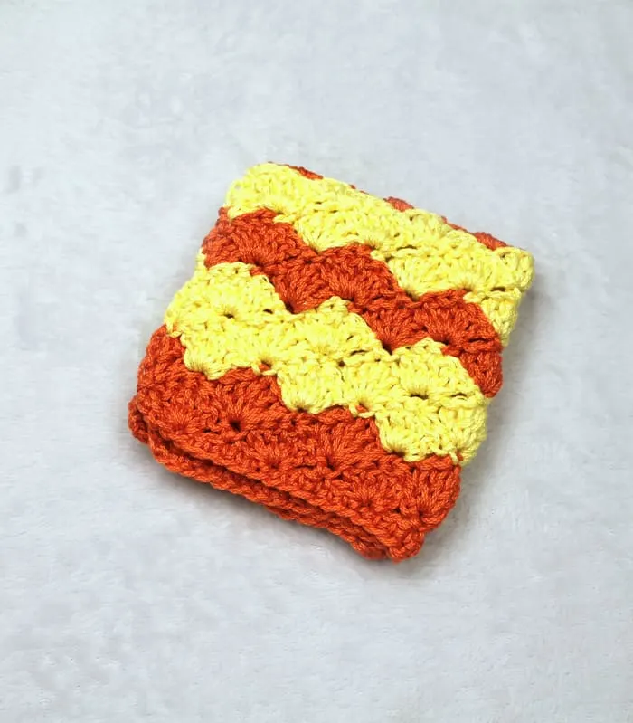 Try this easy shell stitch striped washcloth crochet pattern.