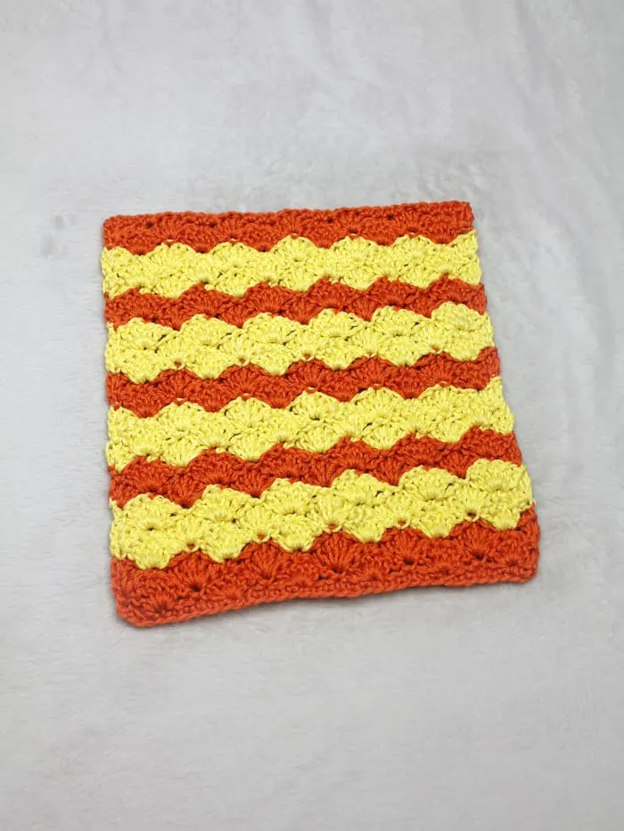 Try this easy shell stitch striped washcloth crochet pattern.