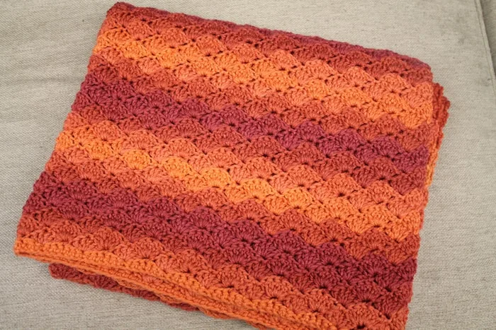 Try this pretty ombre shell stripe crochet blanket pattern. There is a free easy PDF.