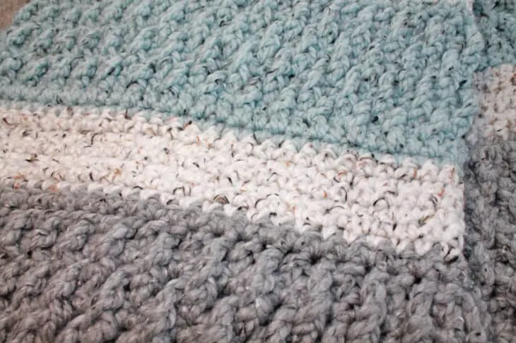 Try this super bulky tweed throw crochet pattern. This blanket uses the alpine stitch and single crochet to make a modern chunky blanket. There is a free printable PDF available.