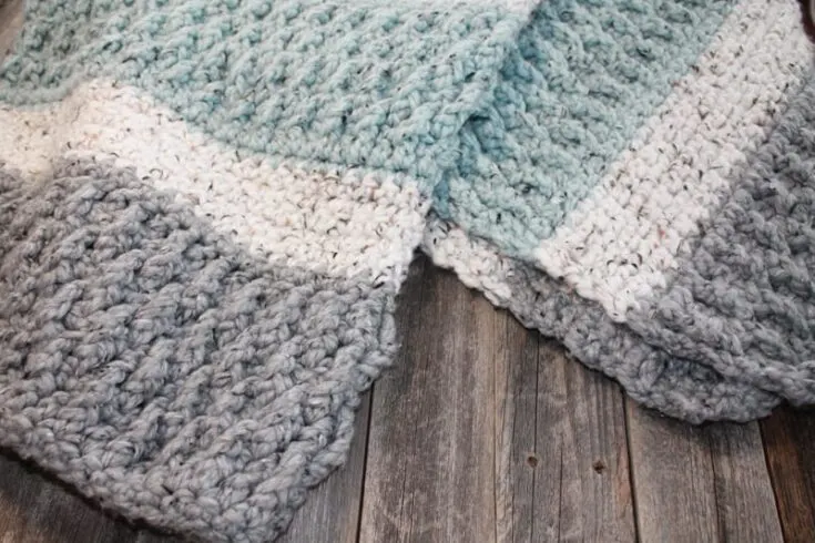 Try this super bulky tweed throw crochet pattern. This blanket uses the alpine stitch and single crochet to make a modern chunky blanket. There is a free printable PDF available.