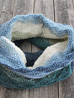 Try this Echo waves cowl crochet pattern. This free PDF make a pretty wave texture with basic stitches.