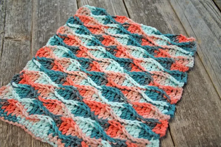 Try this raised wave dishcloth pattern. This pattern uses a repeat of basic stitches to make this eye-catching pattern. There is a free printable PDF available.