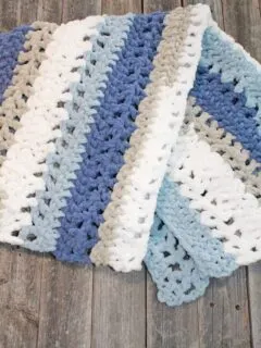 Try this chunky striped baby blanket crochet pattern. This pattern uses easy basic stitches to make a textured blanket. There is a free printable PDF available.