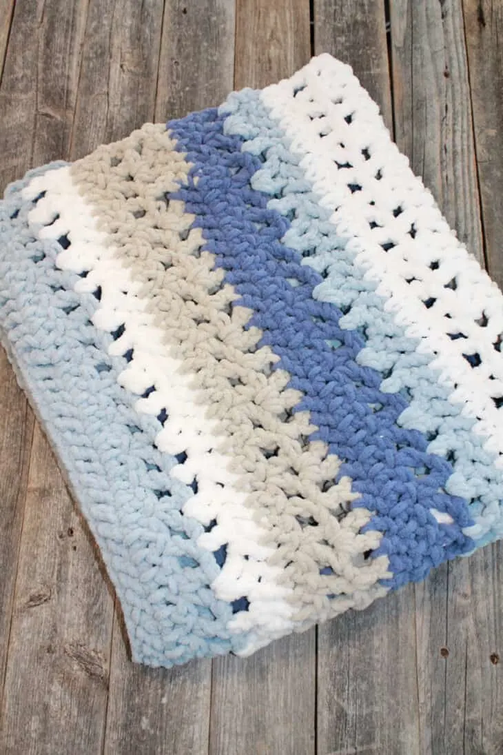 Try this chunky striped baby blanket crochet pattern. This pattern uses easy basic stitches to make a textured blanket. There is a free printable PDF available.