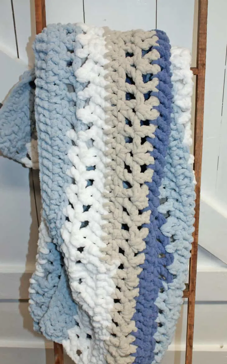 Try this chunky striped baby blanket crochet pattern. This pattern uses easy basic stitches to make a textured blanket. There is a free printable PDF available.