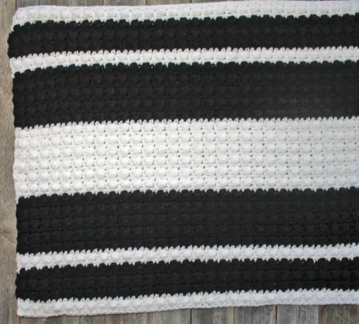 Learn how to make an easy crochet rug. This crochet pattern makes a quick striped rug.