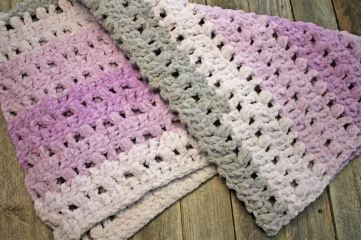 Try this pretty ombre baby blanket crochet pattern. This pattern uses the double crochet stitch and the puff stitch. There is a free printable PDF.