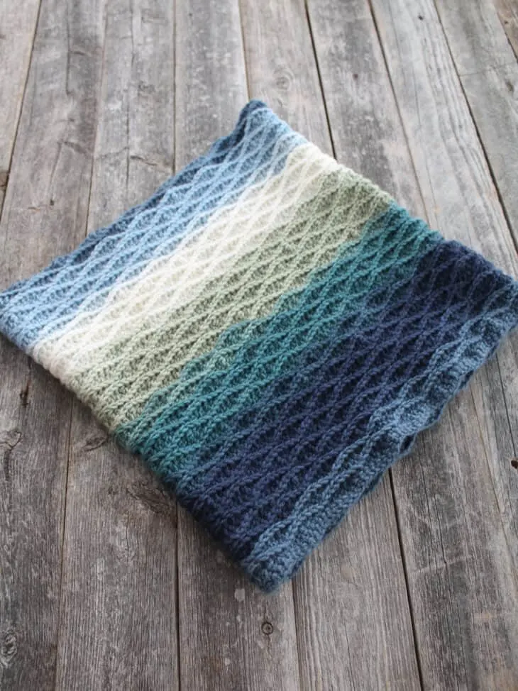 Try this Echo waves cowl crochet pattern. This free PDF make a pretty wave texture with basic stitches.