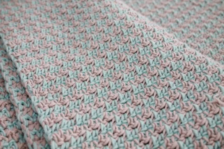 Try this easy baby blanket crochet pattern. This pattern uses to easy stitches to make this modern baby blanket. This soft blanket is make with cotton yarn.