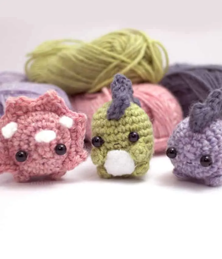 Make your own cute trio of crocheted dinosaurs with this pattern.
