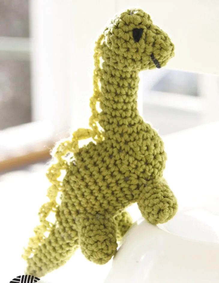 Make your own cute dino with this free crocheting pattern. green free dinosaur crochet pattern
