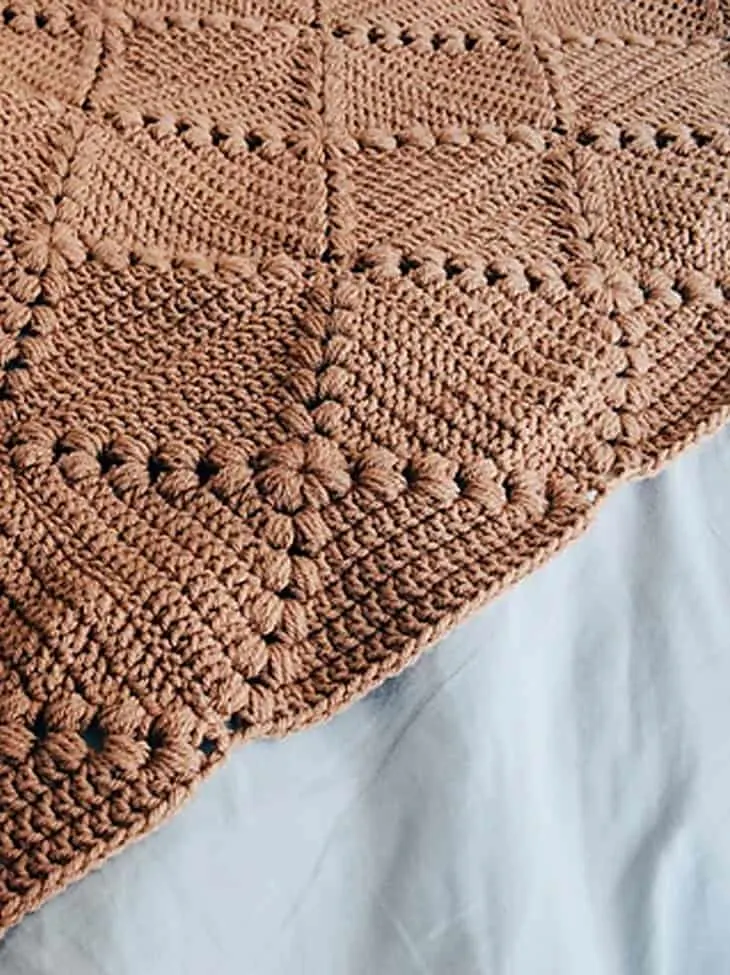 Make this square blanket pattern with raised puffs. 