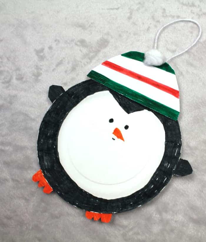 Make a cute paper plate Christmas penguin ornament craft.