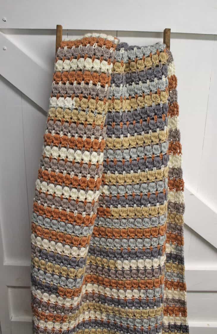 Make your own pretty throw crochet blanket with this easy crocheting pattern using Caron Cakes Yarn.