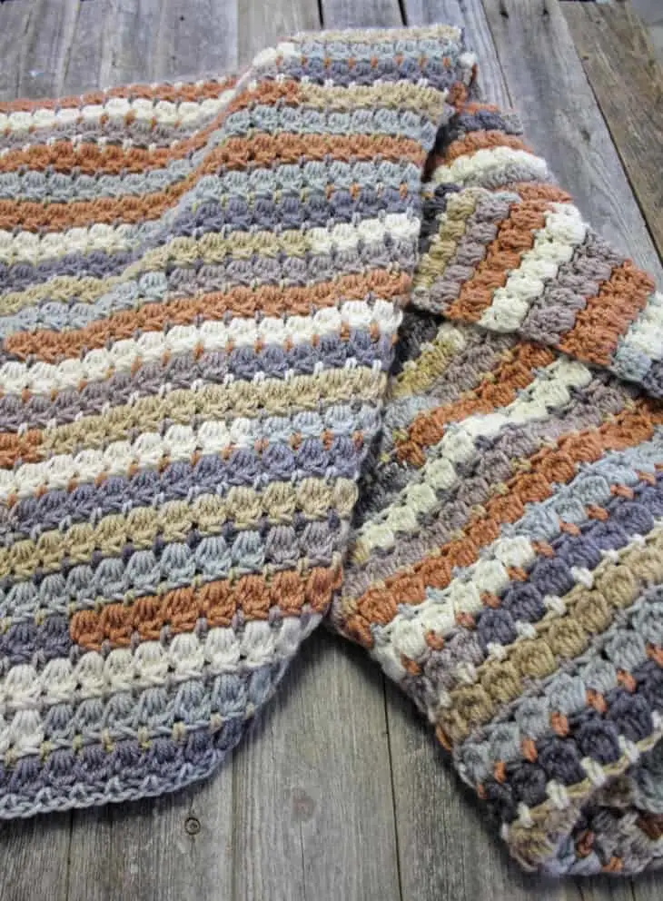 Make your own pretty throw crochet blanket with this easy crocheting pattern using Caron Cakes Yarn.