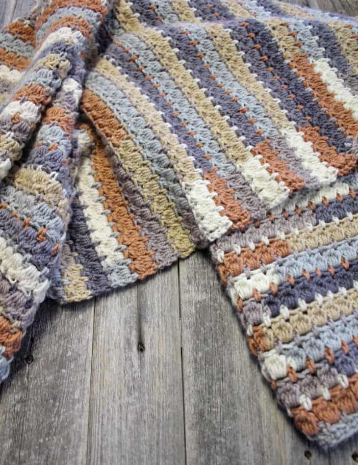 Make your own pretty throw crochet blanket with this easy crocheting pattern using Caron Cakes Yarn.