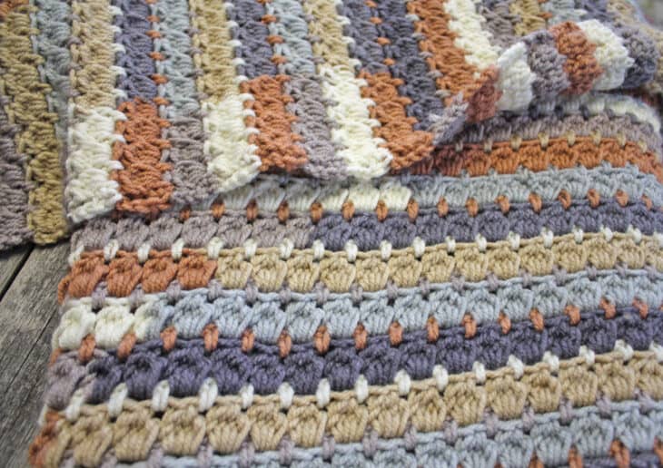 Make your own pretty throw crochet blanket with this easy crocheting pattern using Caron Cakes Yarn.