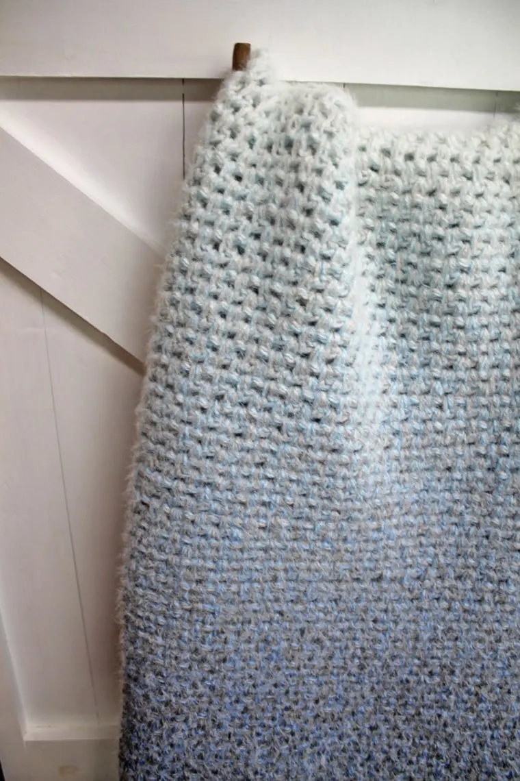 Make this easy moss stitch blanket. This crochet baby blanket pattern is an easy project using single and chain crochet stitches.