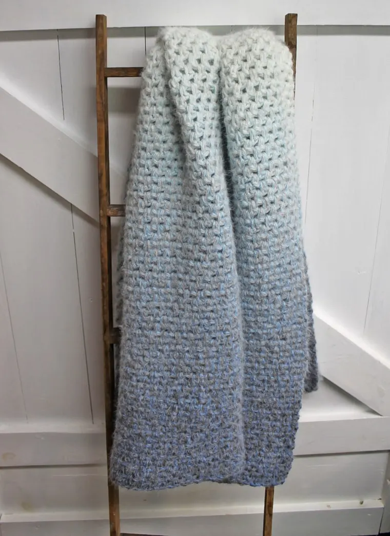 Make this easy moss stitch blanket. This crochet baby blanket pattern is an easy project using single and chain crochet stitches.