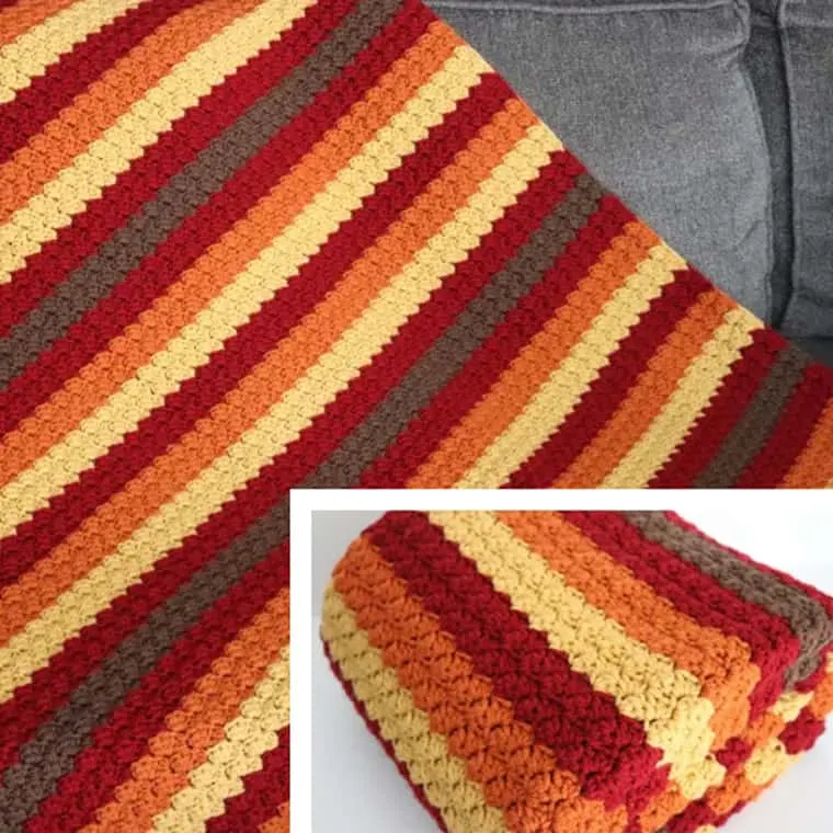 colorful striped crocheted blanket in fall colors