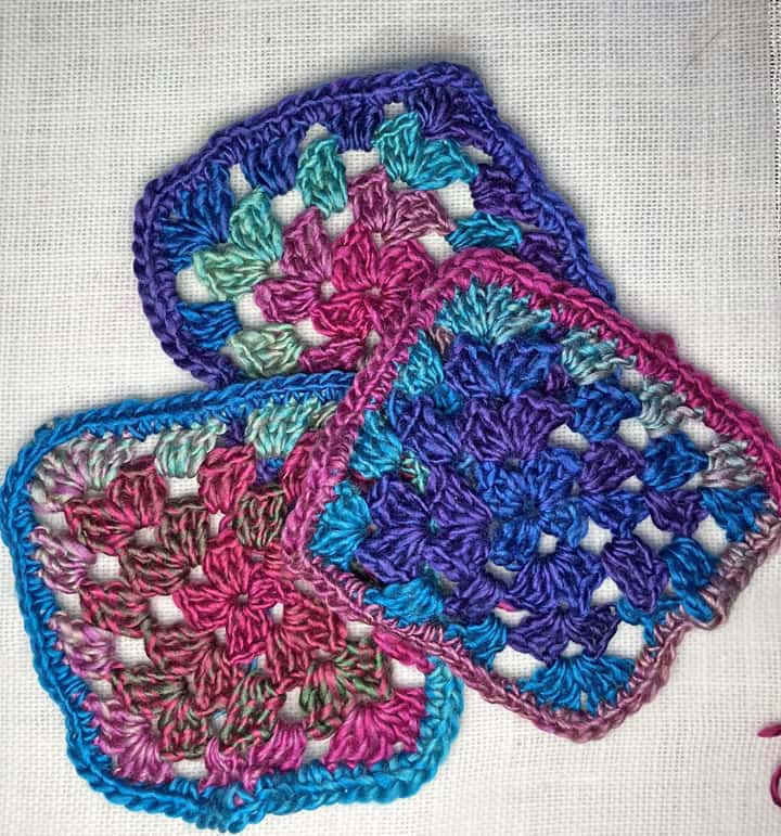 3 crocheted granny squares in Red Heart Unforgettable Yarn in Stain Glass